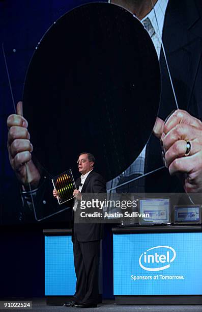 Intel CEO Paul Otellini holds a silicon wafer with a new 22 nanometer SRAM chip as he delivers the keynote address during the 2009 Intel Developer...