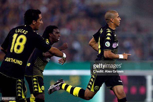 Mohamed Zidan of Dortmund celebrates his team's first goal with team mates Tinga and Lucas Barrios during the DFB Cup second round match between...