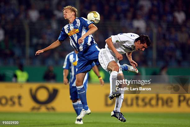 Dennis Grote of Bochum goes up for a header with Christoph Moritz of Schalke during the DFB Cup second round match between VfL Bochum and FC Schalke...