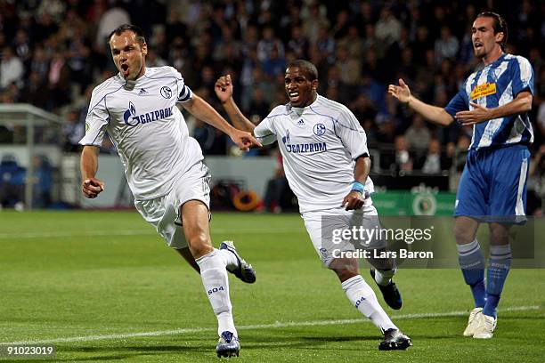 Heiko Westermann of Schalke celebrates scoring the first goal next to team mate Jefferson Farfan and Christian Fuchs of Bochum during the DFB Cup...