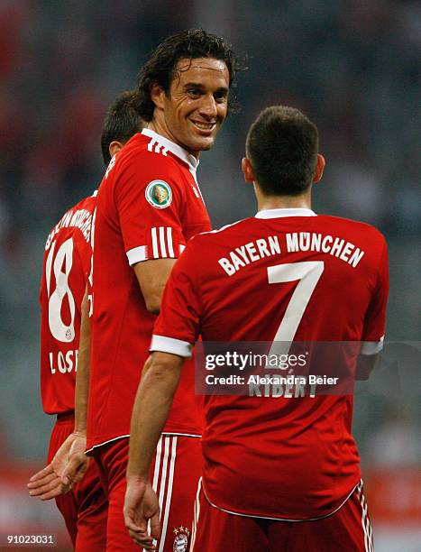 Luca Toni of Muenchen smiles as he talks to his teammate Franck Ribery during the DFB Cup second round match between FC Bayern Muenchen and Rot-Weiss...