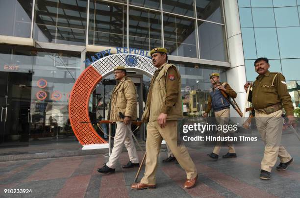 Policemen stand guard at Centre Stage mall during screening of the movie "Padmaavat" on January 25, 2018 in Noida, India. According to the film's...