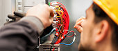 Electrician engineer tests electrical installations on relay protection system
