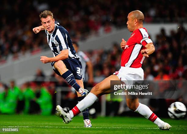Simon Cox of West Bromwich Albion gets a shot past of Mikael Silvestre of Arsenal during the Carling Cup Third Round match between Arsenal and West...