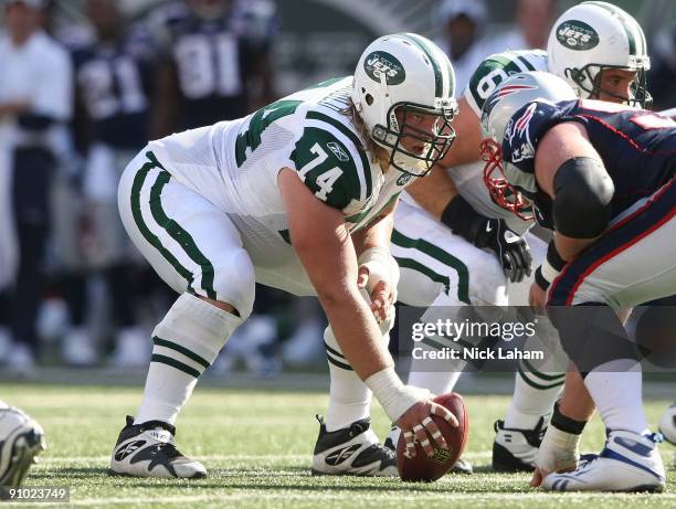 Nick Mangold of the New York Jets waits to snap against the New England Patriots at Giants Stadium on September 20, 2009 in East Rutherford, New...