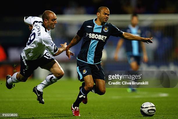 Kieran Dyer of West Ham moves away from Gavin McCann of Bolton Wanderers during the Carling Cup third round match between Bolton Wanderers and West...