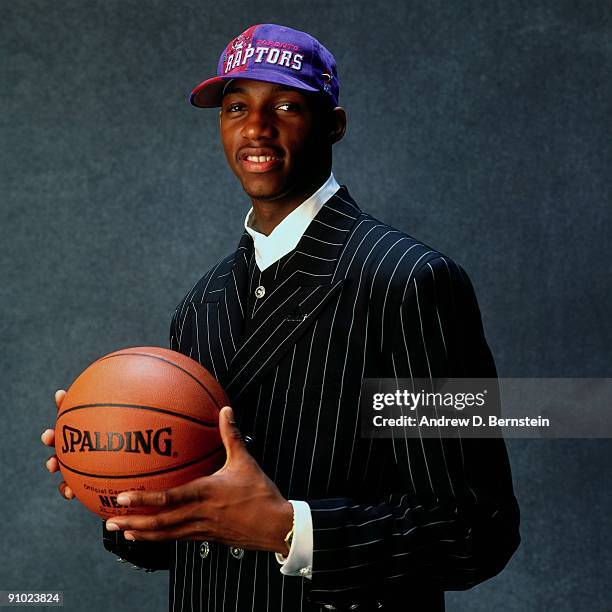 Tracy McGrady poses for a photo after being selected by the Toronto Raptors at the 1997 NBA Draft in New York, New York. NOTE TO USER: User expressly...
