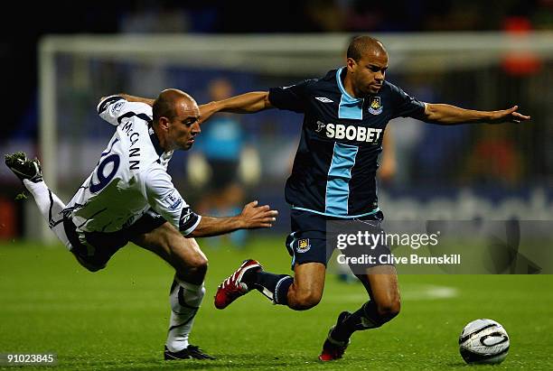 Kieran Dyer of West Ham moves away from Gavin McCann of Bolton Wanderers during the Carling Cup third round match between Bolton Wanderers and West...