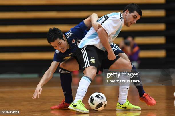 Cristian Borruto of Argentina and Tomoki Yoshikawa of Japan compete for the ball during the Futsal international friendly match between Japan and...