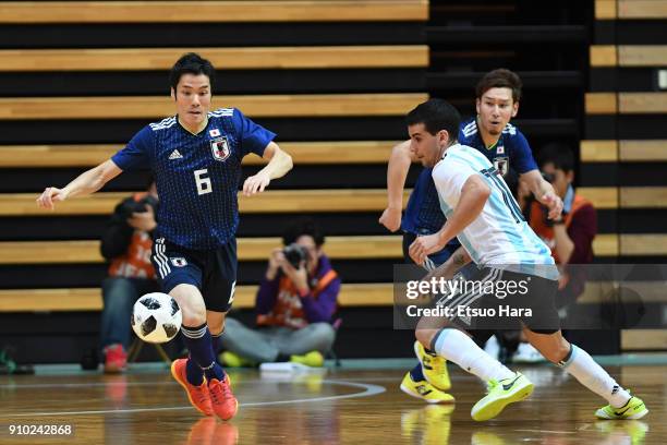 Cristian Borruto of Argentina and Tomoki Yoshikawa of Japan compete for the ball during the Futsal international friendly match between Japan and...