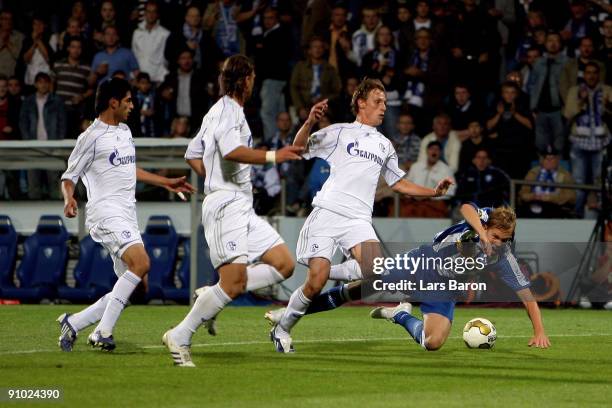 Benedikt Hoewedes of Schalke challenges Dennis Grote of Bochum in the penalty box during the DFB Cup second round match between VfL Bochum and FC...