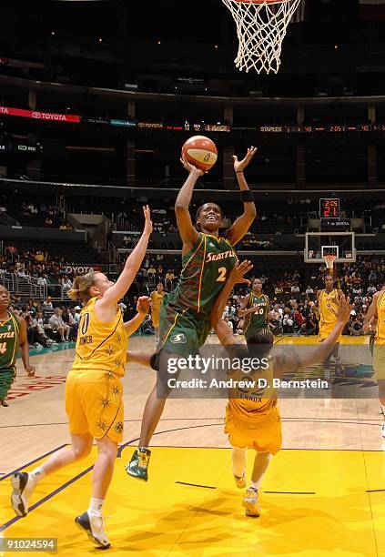 Swin Cash of the Seattle Storm goes to the basket under pressure against Betty Lennox and Kristi Harrower of the Los Angeles Sparks in Game One of...