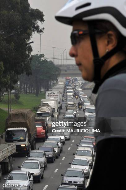 Cyclist gets ready to ride as a huge amount of cars line in a traffic jam during the World Car Free Day, in Sao Paulo, Brazil, on September 22, 2009....