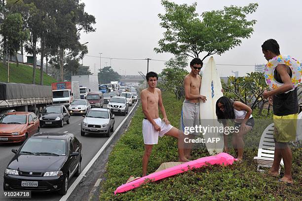 Activists of environmental group 'SOS Mata Atlantica' set up a mock beach scene beside the 'Marginal Tiete' express highway, one of the most heavily...