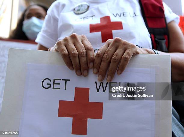 Supporter of single payer health care holds a sign as she protests outside of the Anthem Blue Cross offices September 22, 2009 in San Francisco,...