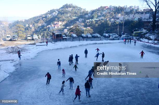 After the spell of snow tourists and locals enjoy ice-skating in Indias only natural ice-skating rink at Lakkar Bazaar on January 25, 2018 in Shimla,...
