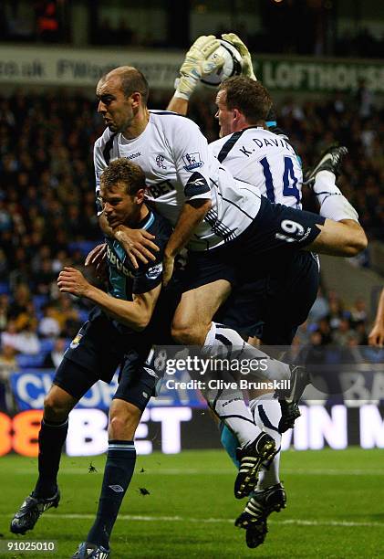 Gavin McCann of Bolton Wanderers holds Jonathan Spector of West Ham United during the Carling Cup third round match between Bolton Wanderers and West...