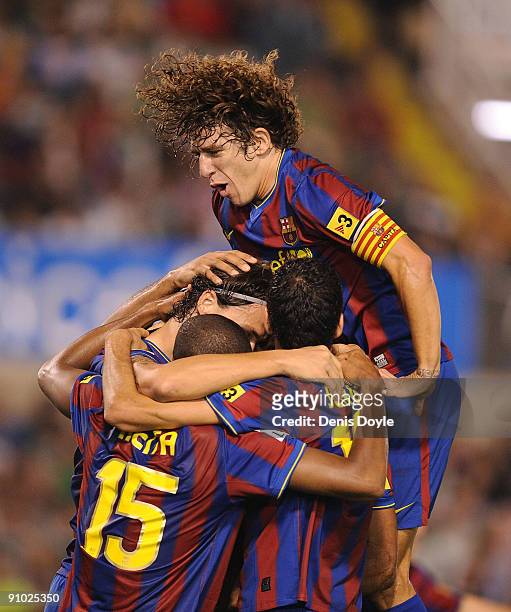 Carles Puyol , Seydou Keita and Barcelona teammates celebrate after their first goal is scored by Zlatan Ibrahimovic against Racing Santander during...