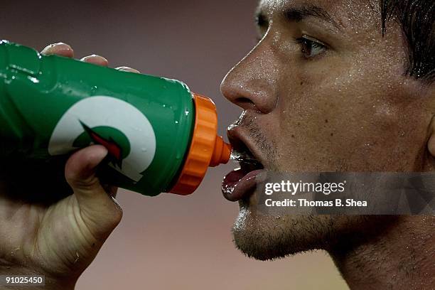 Brian Ching of the Houston Dynamo takes a drink of water during a time out against Real Salt Lake at Robertson Stadium on September 19, 2009 in...