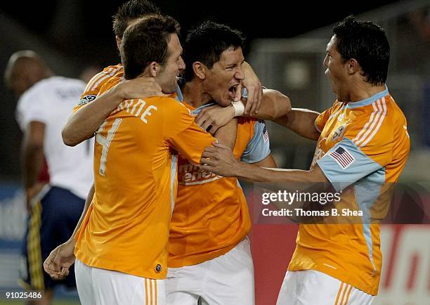 Brain Ching celebrates his goal with teammates Ryan Cochrane and Geoff Cameron of the Houston Dynamo while Jamison Olave of Real Salt Lake walks away...