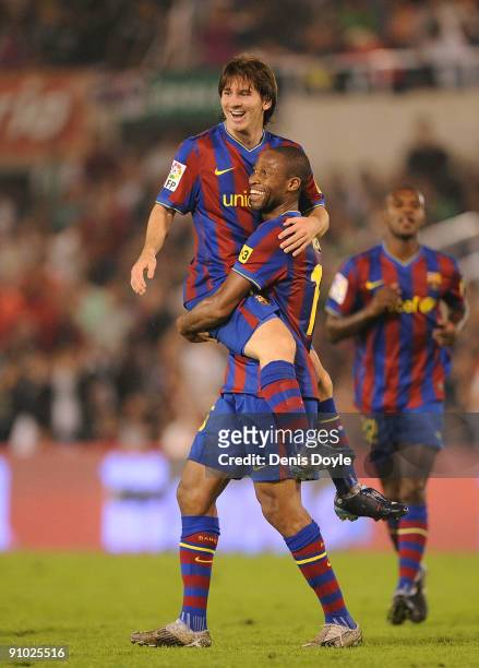 Lionel Messi of Barcelona is lifted up by teammate Seydou Keita after scoring the 4:0 goal against Racing Santander during the La Liga match between...