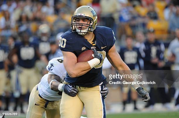 Tight end Nate Byham of the University of Pittsburgh Panthers runs with the football after catching a pass against safety Wyatt Middleton of the Navy...