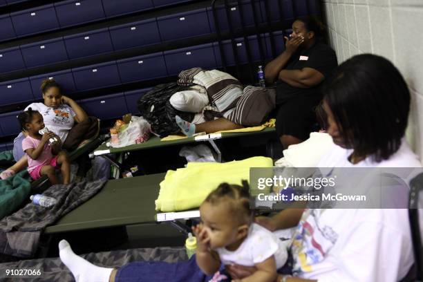 After escaping rising flood waters in West Cobb county, Briaena Davis Vrittany Sabior, Nikisha Miller, Harleiy Jackson, 7-months-old, and Johnnie...