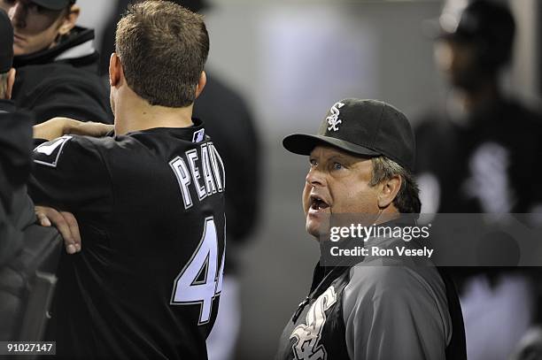 Jake Peavy talks to pitching coach Don Cooper of the Chicago White Sox in the dugout during the game against the Kansas City Royals on September 19,...