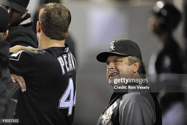 Jake Peavy talks to pitching coach Don Cooper of the Chicago White Sox in the dugout during the game against the Kansas City Royals on September 19,...