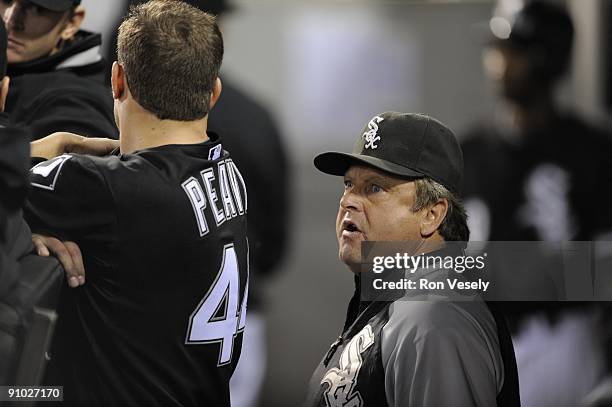 Jake Peavy talks to pitching coach Don Cooper of the Chicago White Sox in the dugout during the game against the Kansas City Royals on September 19,...