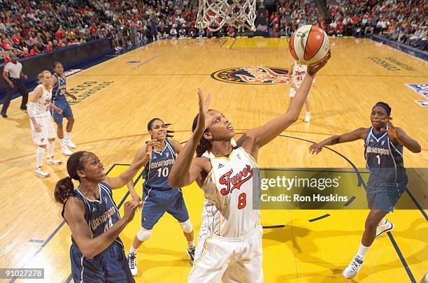 Tammy Sutton-Brown of the Indiana Fever grabs a rebound over Chastity Melvin, Lindsey Harding and Crystal Langhorne of the Washington Mystics in Game...