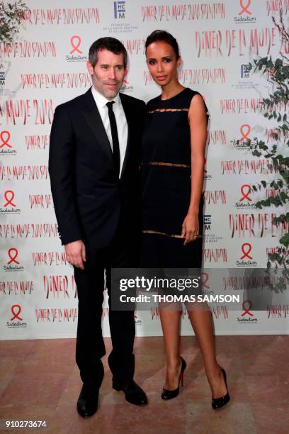 French actor Jalil Lespert and French-Rwandan actress Sonia Rolland pose upon arriving to the Diner de la Mode fundraiser dinner, to benefit the...