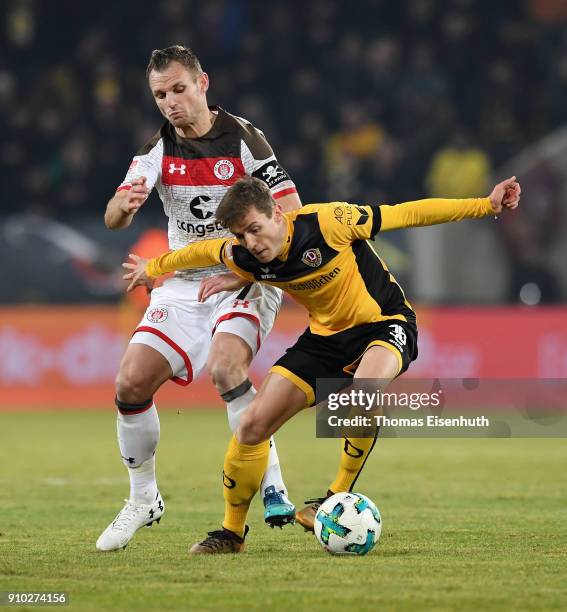 Niklas Hauptmann of Dresden is challenged by Bernd Nehrig of St. Pauli during the Second Bundesliga match between SG Dynamo Dresden and FC St. Pauli...