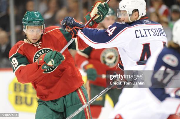 Andy Hilbert of the Minnesota Wild fights off Grant Clitsome of the Columbus Blue Jackets during the first period of a preseason game on September...