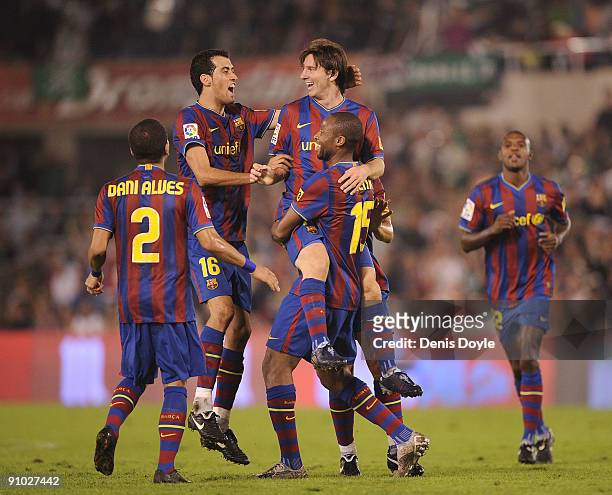 Lionel Messi of Barcelona is lifted up by Seydou Keita after scoring Barcelona's fourth goal against Racing Santander during the La Liga match...