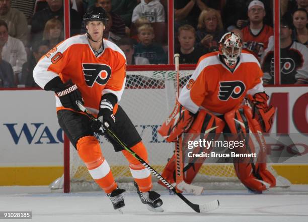 Chris Pronger and goaltender Ray Emery of the Philadelphia Flyers defend their end of the ice against the Detroit Red Wings during preseason action...