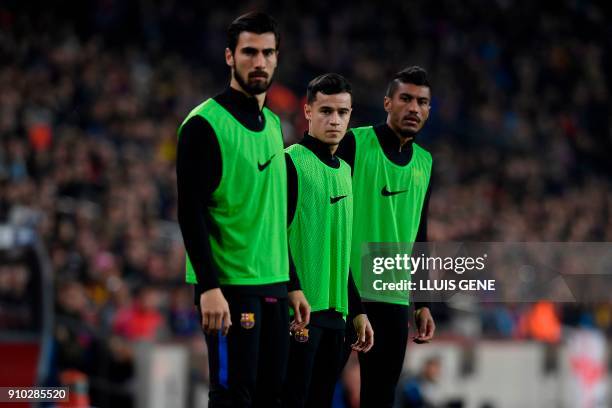 Barcelona's Brazilian midfielder Philippe Coutinho warms up with Barcelona's Portuguese midfielder Andre Gomes and Barcelona's Brazilian midfielder...