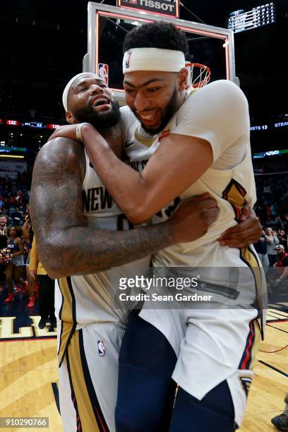 DeMarcus Cousins of the New Orleans Pelicans is congratulated by Anthony Davis of the New Orleans Pelicans after completing a tripple double during a...