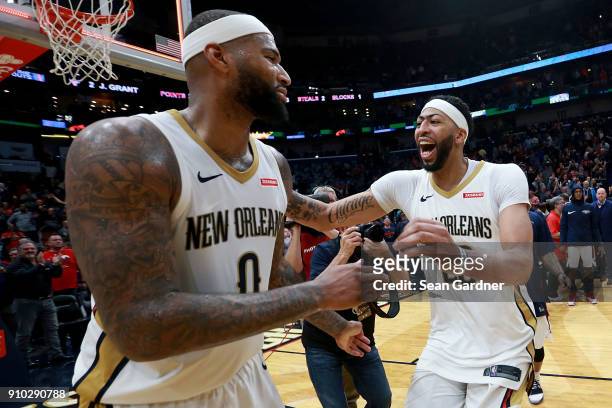 DeMarcus Cousins of the New Orleans Pelicans is congratulated by Anthony Davis of the New Orleans Pelicans after completing a tripple double during a...