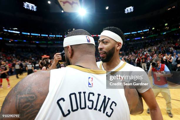 DeMarcus Cousins of the New Orleans Pelicans is congratulated by Anthony Davis of the New Orleans Pelicans after completing a tripple double during a...