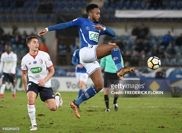 Strasbourg's French defender Yoann Salmier vies with Lille's Argentinian forward Ezequiel Ponce during the French Cup football match between...