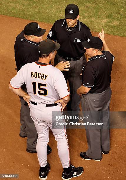 Manager Bruce Bochy of the San Francisco Giants argues with umpires Wally Bell, Angel Campos and Marty Foster after Gerardo Parra , hit a double that...