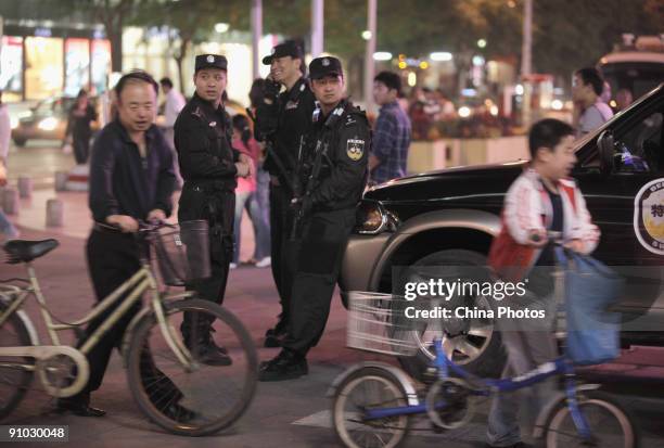 Policemen stand guard at the Wangfujing Pedestrian Street on September 22, 2009 in Beijing, China. Security has been tightened as Chinese people are...