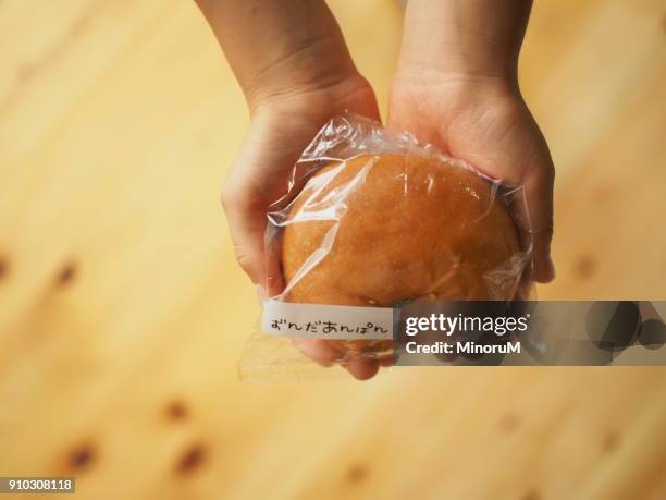 hands holding bread - sweet bun stock pictures, royalty-free photos & images