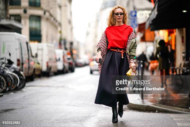 Elina Halimi wears sunglasses, a scarf, a red top, a skirt, a yellow Kill Bill clutch, outside AF Vandervorst, during Paris Fashion Week -Haute...