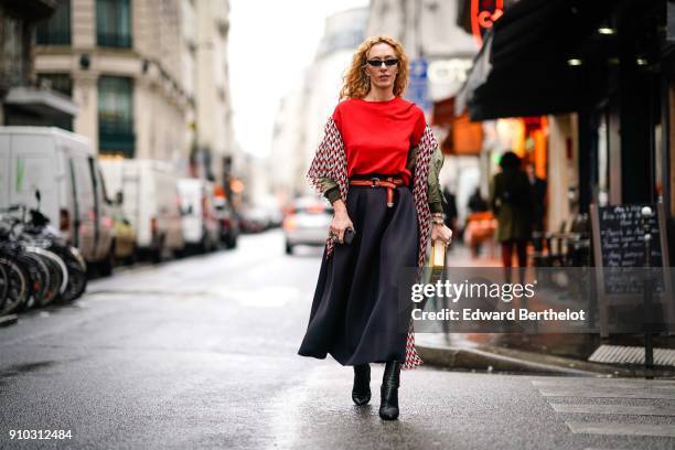 Elina Halimi wears sunglasses, a scarf, a red top, a skirt, a yellow Kill Bill clutch, outside AF Vandervorst, during Paris Fashion Week -Haute...