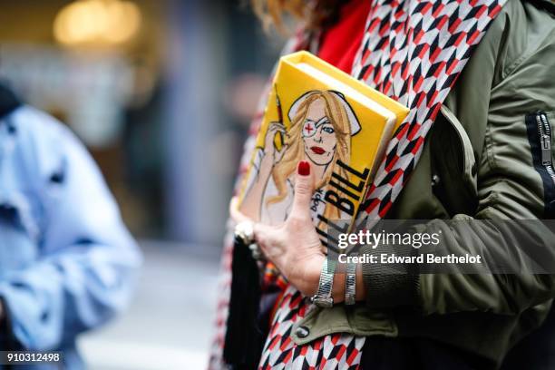 Elina Halimi wears sunglasses, a scarf, a red top, a skirt, a yellow Kill Bill clutch, outside AF Vandervorst, during Paris Fashion Week -Haute...