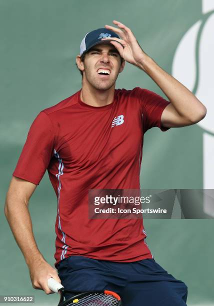 Reilly Opelka adjusts his cap while waiting for a high hit ball in the sun to come his way during a match against Dennis Novikov during the Oracle...