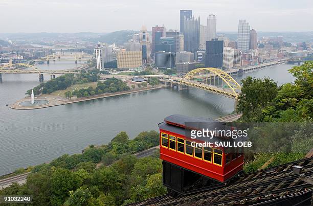 Cable car on the Duquesne Incline, a funicular railway, climbs a hill overlooking downtown Pittsburgh, Pennsylvania, on September 22 as the city...