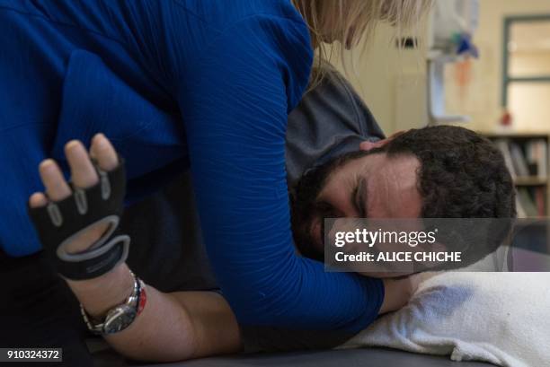 Aymen Derbali a victim of the Quebec City mosque attack, undergoes rehabilitation exercises on January 25, 2018 in Quebec City, Canada. Derbali has...